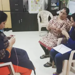 Here you can see a typical class setting where I'm helping two students at once. We create a comfortable, friendly atmosphere where everyone can learn at their own pace and feel supported.