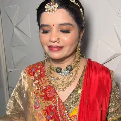 A beautiful, traditional look for the mother of the bride. The makeup is elegant and sophisticated, enhancing her features without being too heavy.