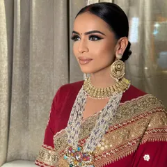 For this classic bridal look, I created a dramatic winged eye to complement the traditional red Sabyasachi saree. The skin is kept luminous with a neutral lip, ensuring the focus remains on her expressive eyes and the intricate details of her outfit.