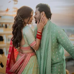 An intimate couple portrait from their Mehendi event, set against the backdrop of a heritage location at sunset.