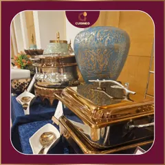 We use a variety of ornate and modern serving dishes, like these stunning blue and gold pieces, to match the theme and style of your event. It's about creating a visual feast that complements the culinary one.