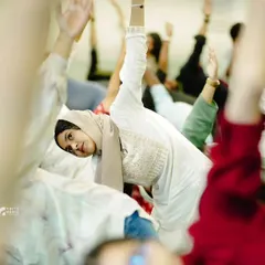 Participants in a corporate session engage in a full-body stretch. I guide groups through sequences that are accessible to all levels, ensuring everyone feels included and can experience the benefits of increased flexibility and energy.