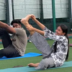 Laughter and focus go hand in hand. During this partner stretch at the Withum session, employees helped each other deepen their poses, building both flexibility and camaraderie.