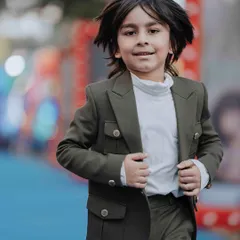 A candid moment of joy. These brothers are comfortable and stylish in their matching outfits, designed for both looks and play.