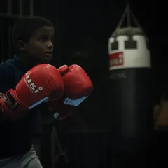 A young boxer in his stance, ready for action. We teach them to be calm and focused, even in the heat of the moment.
