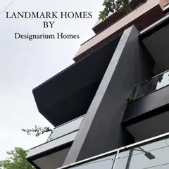 A corner detail of a recently completed modern residence, showcasing sharp, angular silhouettes and the juxtaposition of dark metal cladding with clear glass railings. This image captures our ability to translate bold architectural concepts into precisely executed structures.