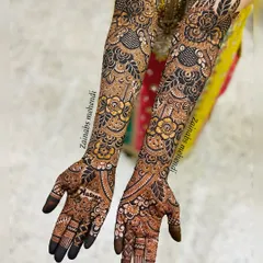 Full bridal arms featuring a beautiful mix of styles. The large flowers provide a bold statement, while the intricate netting and paisleys add depth and richness.
