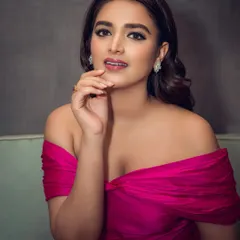 A full-length portrait of actress Nidhhi Agerwal in a stunning magenta gown. This shot was taken for an event, capturing her elegance and the dress's beautiful silhouette.