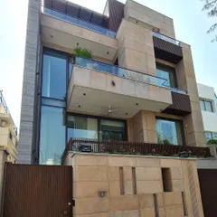 An architectural harmony of materials, where glass meets textured layers of stone and wood. The beige and brown tones create a calm yet captivating exterior, resulting in a home that is a masterclass in modern serenity.