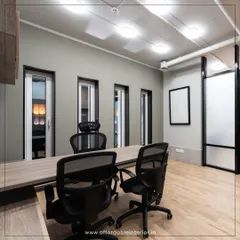 A minimalist executive office designed for focus and clarity. The simple color palette, clean lines of the furniture, and uncluttered layout create a calm and productive environment for leaders.
