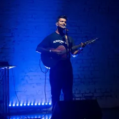 A full-length shot from my performance at AntiSocial. It shows the simple, focused setup of my solo gigs: just me, my guitar, and the stage.