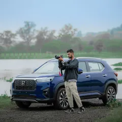 A behind the scenes shot of me with the Honda Elevate during our shoot. Having the right gear, like my Sony camera, allows me to capture the vehicle's design and performance from the best angles, even in natural, outdoor lighting.