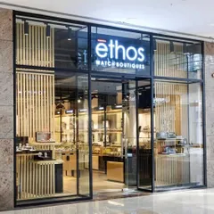 The striking facade of the Ethos Watch Boutiques in Guwahati. We used a combination of glass, blackened steel, and vertical wood slats to create a modern and inviting entrance that reflects the premium nature of the brands within.