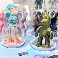 A collection of fluid bear statues in various stages of the pouring process, showing the endless color possibilities.