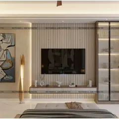 The media wall in this bedroom is designed with fluted paneling and a floating console. A tall, fluted glass display cabinet provides elegant storage, while a large piece of abstract art adds a personal touch.