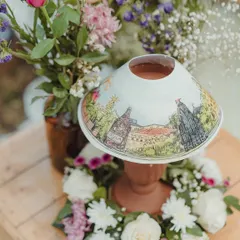 A truly unique detail. We commissioned hand-painted lampshades depicting scenes from the local area, turning a simple table lamp into a piece of art and a conversation starter.