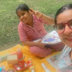 Our pyjamas are perfect for all-day wear, especially in the summer. Here's a girl enjoying a picnic and painting session outdoors in our red woven checks pyjama set.