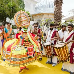 A surreal and magnificent entry for a South Indian themed Haldi ceremony. The groom's arrival was accompanied by Kathakali dancers and traditional drummers, creating an authentic and powerful cultural experience.
