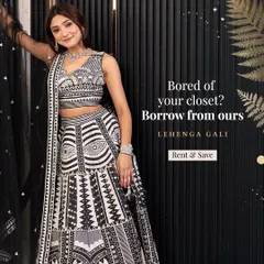 Stand out from the crowd with this unique black and white lehenga featuring bold geometric patterns and mirror work. It's a contemporary take on traditional wear, perfect for a fashion-forward guest at a wedding reception or cocktail event.