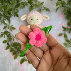 A close-up of a pretty pink flower I made as an accessory for a little crochet lamb. It shows how my flowers can be used to customize other handmade items.