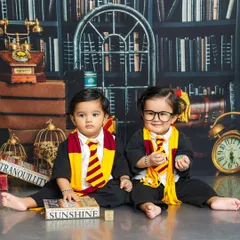 Double the magic. These twin wizards are exploring the world of spells together, one with a curious look and the other with a charming smile and glasses.