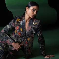 A duplicate of image 57, this shot from the Advait campaign showcases the detailed beadwork and rich colors of the blazer against a dark, moody background.