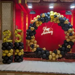 A closer look at the black and gold circular balloon arch and neon sign. This combination is perfect for evening events and adds a modern, elegant touch to anniversary or milestone parties.