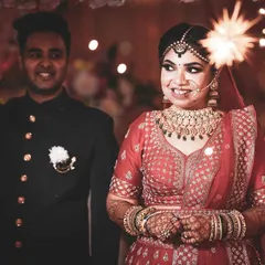 The bride's entrance is always a magical moment. Here, she walks in with a sparkling phuljhadi, her smile lighting up the frame as she makes her way to the stage.