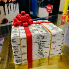 Another view of the stacks of cash cake, highlighting the realistic detail on the edible printed bills.