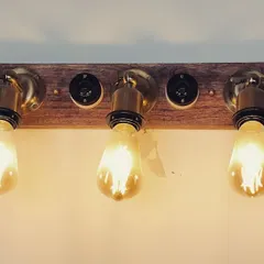 For a more industrial or rustic vibe, I often use custom fixtures like this vanity light. The combination of a warm wood base, brass fittings, and exposed Edison bulbs provides a warm, ambient glow that is perfect for cafes, bars, or boutique hotel restrooms.