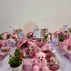 It's a girl! We love creating these adorable pink-themed pram hampers to welcome a little princess. This one includes a cute teddy, a live plant, and sweet treats, all arranged on a beautiful MDF base.