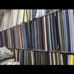 The view inside my shop, with bolts of suiting fabric organized and ready for you to browse. I can help you select the perfect material for your needs.