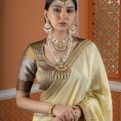 This model is adorned in a complete bridal look featuring our layered Kundan and pearl necklace set, matching chandbali earrings, and an ornate maang tikka. The set is designed for a grand, traditional wedding ceremony.