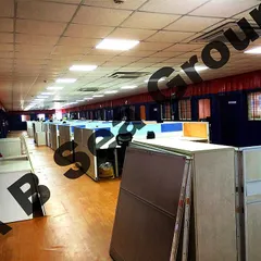 The interior of a large prefabricated office shelter, fully fitted with cubicles, lighting, and flooring. We deliver ready-to-use office environments that can accommodate a large workforce.