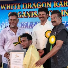 A moment of honor, receiving an award and certificate of appreciation at the White Dragon Karate Do event.