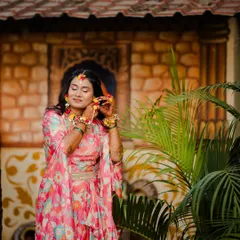 Adjusting her floral earrings, this candid shot captures the fun and festive spirit of a pre-wedding event.