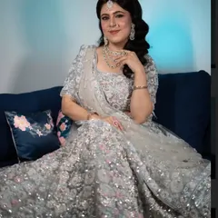 For this reception look, I created a full-glam style with a glittering silver lehenga. The hair is styled in soft, side-swept waves, paired with a smokey eye and a flawless base.
