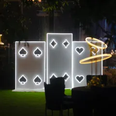 A fun and thematic photo-op for a Diwali card party, featuring large, illuminated panels of playing card suits.
