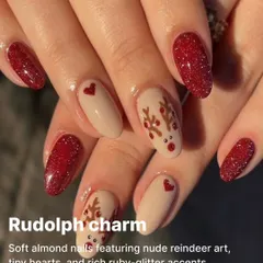 A charming Rudolph-inspired design on soft almond nails, featuring nude reindeer art, tiny hearts, and rich ruby-glitter accents.