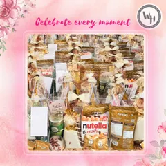 "Celebrate every moment" is my philosophy, and it's reflected in the care I take with large orders. This image shows another angle of a bulk delivery, with each hamper containing treats like Nutella and Farmley dry fruits.