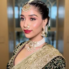 A stunning close-up of the Maharashtrian bride. The look features a modern take on tradition, with flawless skin, a bold red lip, and the iconic nath, all coming together to whisper royalty.