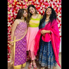 Celebrating with friends at a wedding event. I'm wearing a royal blue Anarkali with a contrasting bright pink dupatta. This shows how to play with bold colors for a stunning festive outfit.
