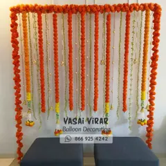 Here is a classic and vibrant backdrop we designed, perfect for a Haldi ceremony or a naming ceremony. We used strings of fresh orange marigold flowers to create a simple yet beautiful photo corner, bringing a touch of tradition to the event.