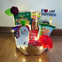 This charming Rakhi basket is lit with warm fairy lights for an extra festive feel. It's filled with snacks, a Paper Boat drink, and chocolates, and decorated with artificial flowers and an 'I Love My Brother' sign.