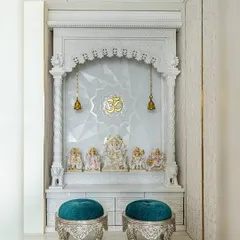 A closer look at the 'Urban Oasis' mandir. The detailed marble carving and the geometric pattern on the back wall create a space that is both traditional and contemporary.