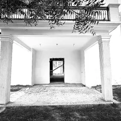 A view of the main entrance before our work began. Our plan involves reimagining this entire entryway to create a more modern and welcoming facade.