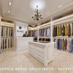 An interior view of the "NINE" boutique design. The layout features well-lit, organized clothing displays, a central island for accessories, and a classic chandelier, all designed to provide a sophisticated and seamless shopping experience.