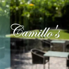 A glimpse of our outdoor seating area through the glass door, with the lush greenery of the garden just beyond. This is the view that welcomes you to your neighborhood artisanal pizzeria.