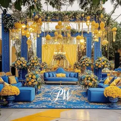 A bold and beautiful Mehendi stage. The combination of royal blue and vibrant yellow, accented with traditional motifs and lush marigold flowers, creates a stunning and regal look.
