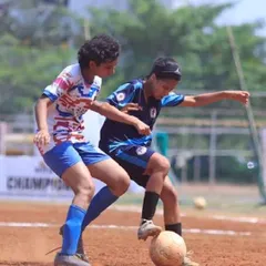 Prisha shields the ball from an opponent, showcasing the strength and skill honed at our academy. We focus on building ambitious and technically proficient female footballers.